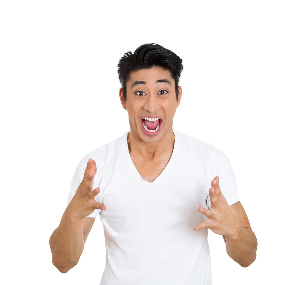 Closeup portrait happy young handsome man looking shocked surprised in full disbelief hands in air open mouth eyes, ecstatic isolated white background. Positive human emotion facial expression feeling