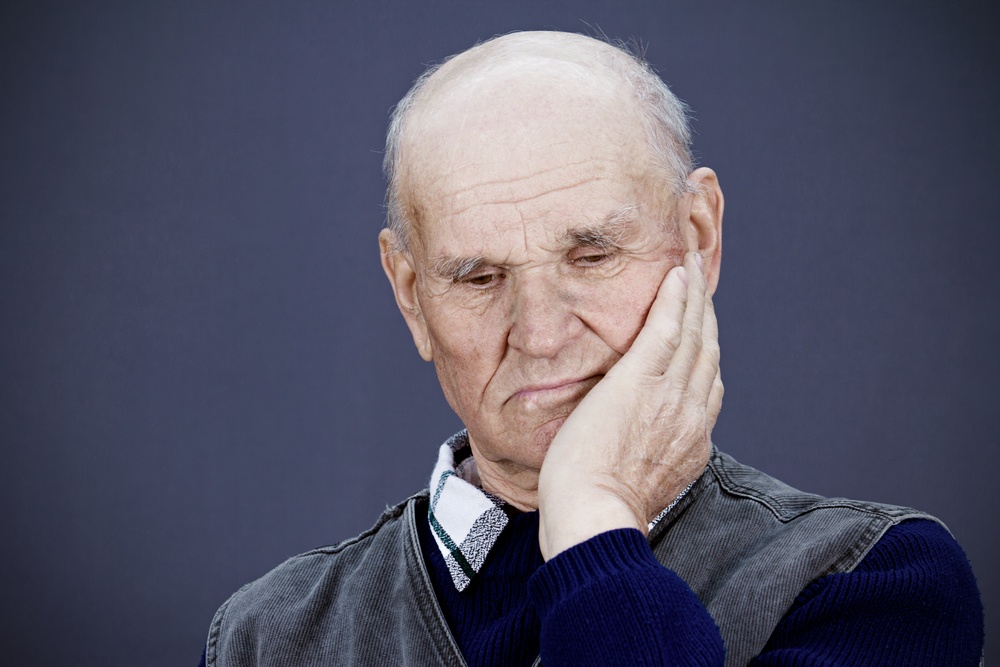 Closeup portrait senior, elderly, mature, sad depressed man, deep in thought, thinking, realizing truth, looking down isolated black background. Human face expressions, emotions, feeling, reaction