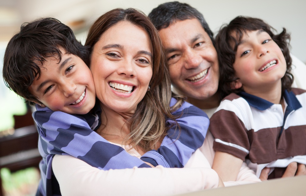 Happy family portrait smiling together at home